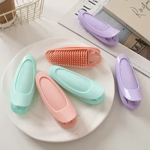 Detail of hair root volumizing clips showing internal teeth structure in pastel colors