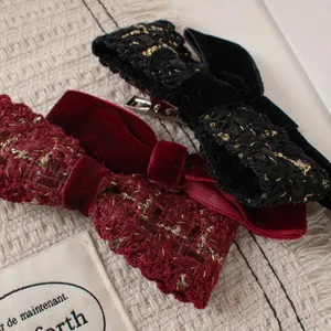 Detail of velvet and tweed double bow hair clip with a metal alligator base