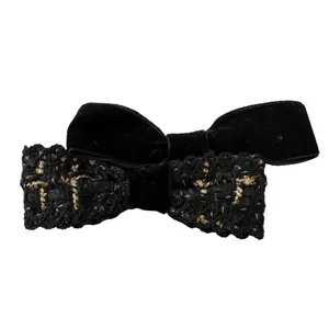 Vintage velvet and tweed double bow hair clip with gold accents on white background