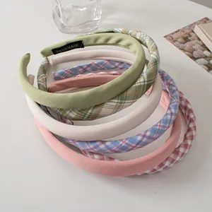 Group of solid color and plaid fabric sponge headbands with handmade label detail