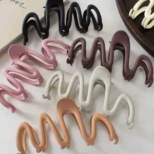Close-up of matte wave hair claws in diverse earth tones for sophisticated hairstyles