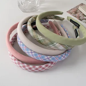 Detail of handmade padded fabric headbands in assorted pastel colors and plaid patterns