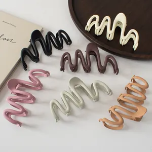 Flat lay of six large matte finish wavy hair claws in various elegant Morandi colors