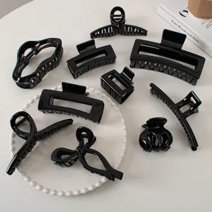 Set of minimalist glossy black hair claws in various geometric shapes and bow designs