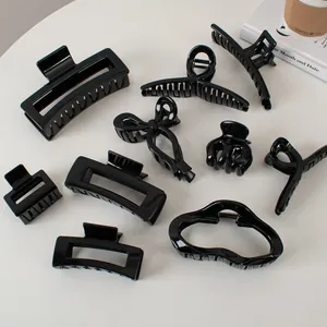 Set of minimalist glossy black hair claws in various shapes for women's hair styling