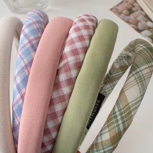 Padded fabric headbands in solid colors and plaid patterns with handmade detail labels
