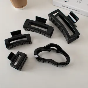 Set of 5 glossy black hair claw clips in various hollow minimalist shapes for women