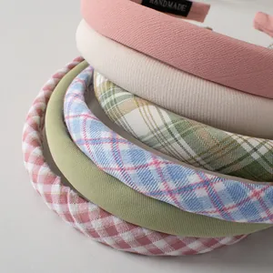 Detail of multi-colored sponge headbands showing thick woven fabric and handmade label