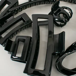 Close-up of glossy black hair claws with smooth mirror finish and secure grip teeth