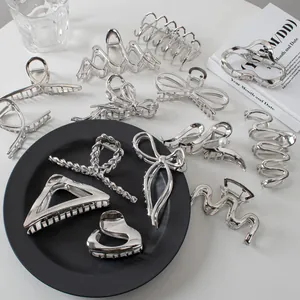Detailed collection of silver metal hair claws in various geometric and bow shapes