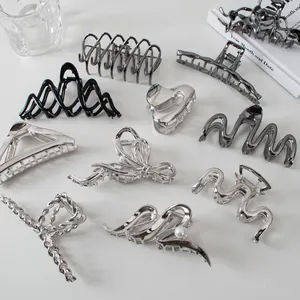 Collection of metallic hair claws in silver, charcoal, and matte black finishes