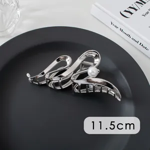 Close-up of 11.5cm silver metal hair claw clip with pearl detail and hollowed lines