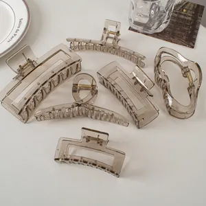 Detail view of 6-piece set of translucent grey hair claws in various geometric shapes