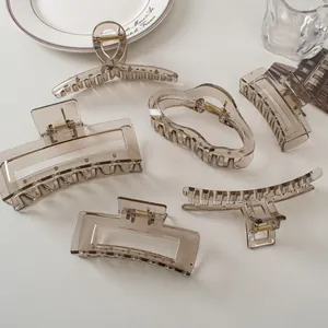 Collection of large translucent grey hair claws in various elegant geometric shapes
