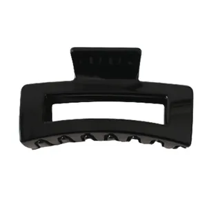 Glossy black rectangular hollow hair claw clip with geometric minimalist design for women