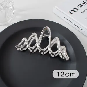 Detail showing the 12cm silver metal hair claw clip with its wave design and metallic spring