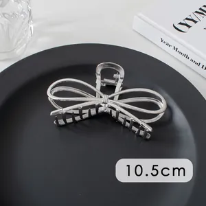 Macro shot of 10.5cm silver bow-knot metal hair claw clip with glossy finish