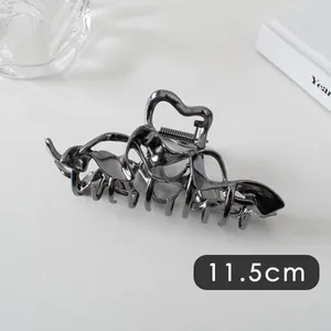Detail of 11.5cm dark gray metal hair claw clip with sleek cutout design for women