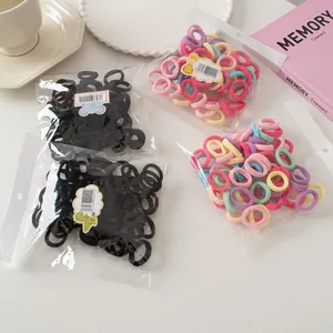 Detail of multi-colored high-elastic hair ties in transparent bags with cartoon labels