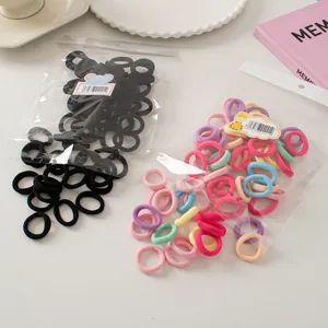 Macro detail of high-elasticity seamless hair ties in black and pastel mixed colors