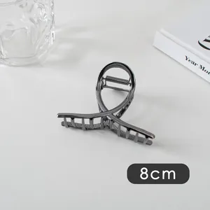Detail of 8cm gunmetal grey hair claw clip showing metallic cross curve design