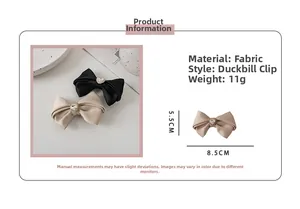 Detail showing dimensions of 8.5x5.5cm and heart rhinestone on satin bow hair clip