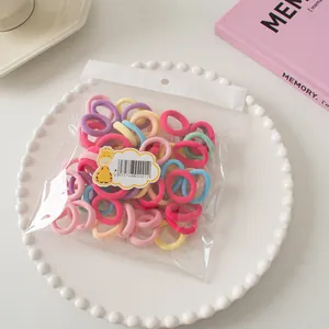 Detailed macro of assorted colorful seamless elastic hair ties in a clear poly bag