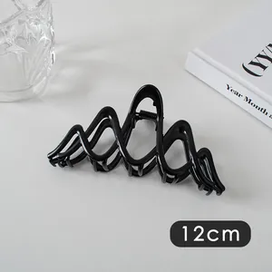 Detail view of 12cm large black wave hair claw clip for thick hair styling