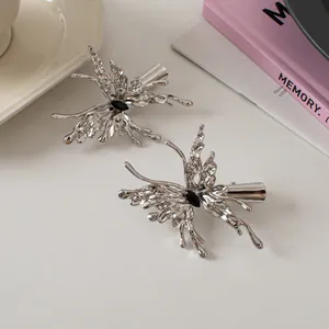 Pair of liquid metal butterfly hair clips in shiny silver finish with black center stones