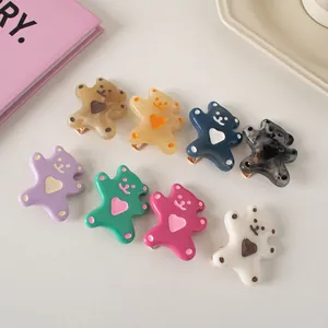 Close-up of 8-piece set of cartoon bear hair clips with colorful heart patterns