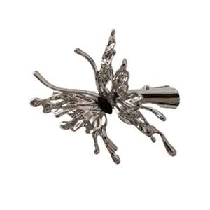 Silver liquid metal butterfly hair clip with black gemstone accent on white background