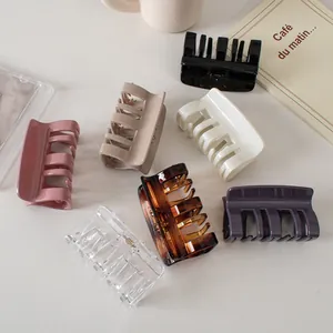 Detail of 7 colors glossy rectangular hair claws set in neutral and amber tones