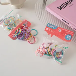 Detail of macaron color hair ties in MSMP branded clear pouch with 35 pieces
