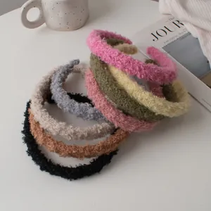 Detail showing a variety of soft lamb wool headbands in diverse autumn colors