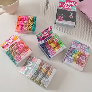 Close-up of multicolored elastic hair bands in a square gift box for kids