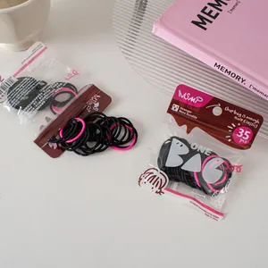 Macro detail of high-elastic hair ties in black and pink with MSMP zipper packaging