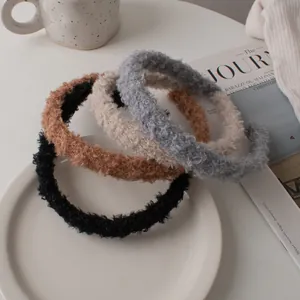 Set of four plush lamb wool headbands in black, brown, cream, and blue for winter fashion