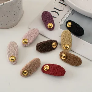 Eight oval plush hair clips in assorted candy colors with vintage golden metal buckles
