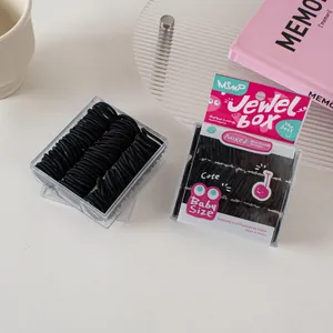Close-up of black high-elastic hair ties in a transparent square baby size jewel box