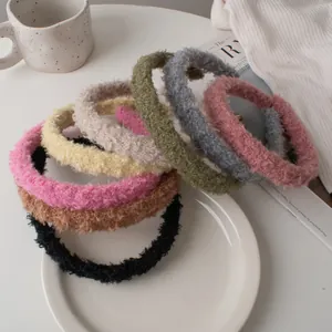 Close-up of soft lamb wool headbands in various colors displayed on a white plate