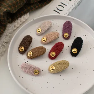 Detail of wool texture hair clips with gold metal studs in nine autumn colors