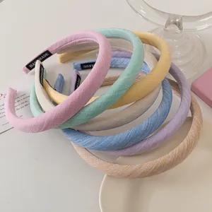 Close-up of macaron fabric headbands with handmade labels and twill woven texture