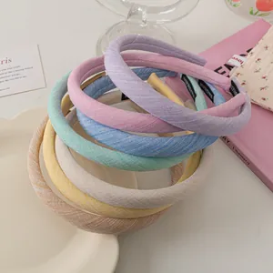 Close-up of colorful thick fabric headbands with handmade labels and soft texture