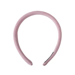 Pale pink fabric headband with high top design and soft texture on white background