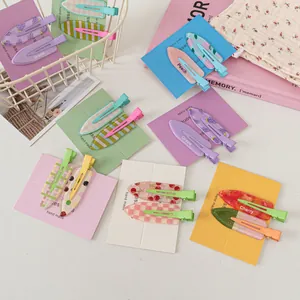 Assorted colorful fruit pattern hair clips with checkers, dots, and cherry prints for styling
