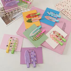Close-up of colorful fruit-patterned seamless hair clips on decorative cards