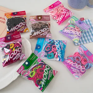 Detailed close-up of colorful baby size elastic hair ties in a cozy lifestyle setting
