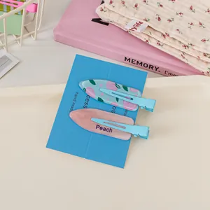 Macro detail of seamless peach print hair clips on a decorative display card