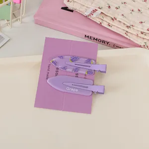 Close-up of purple fruit themed hair clips with grape pattern and Grape letter design