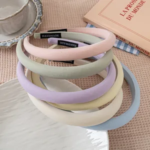 Set of colorful padded sponge headbands in macaron colors with handmade woven labels